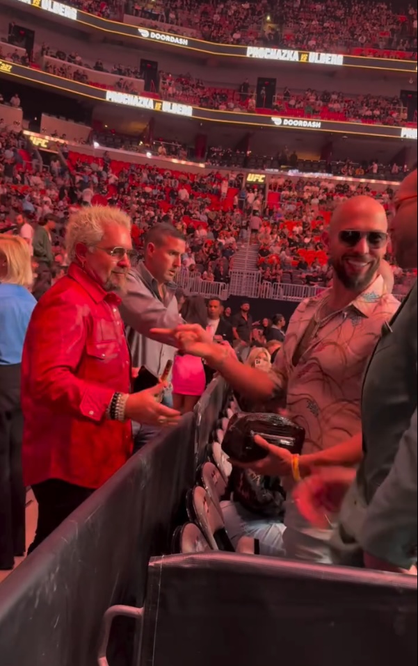 Guy Fieri and Andrew Tate shake hands at a UFC event.