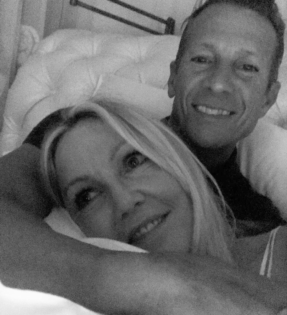 Heather Locklear and Chris Heisser smiling together.