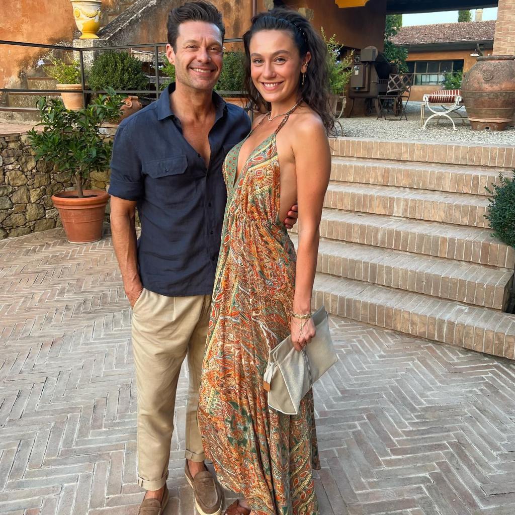 Ryan Seacrest and Aubrey Paige posing together.