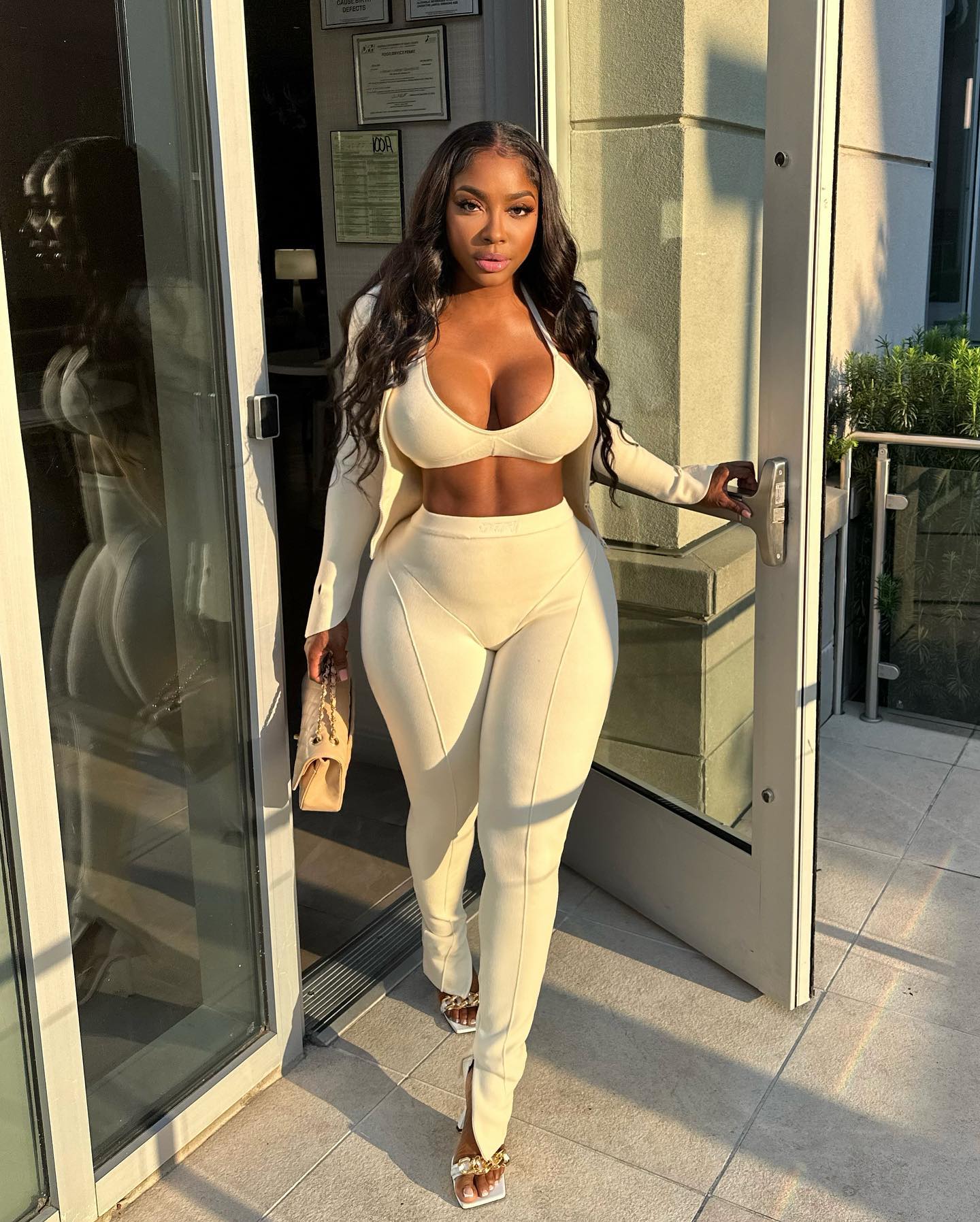 Ayesha Howard in a cream bra, blazer, and split-hem pants.