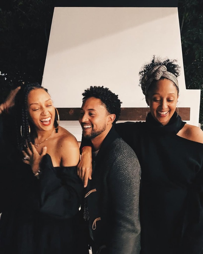 Tia, Tahj, and Tamera Mowry laughing together.