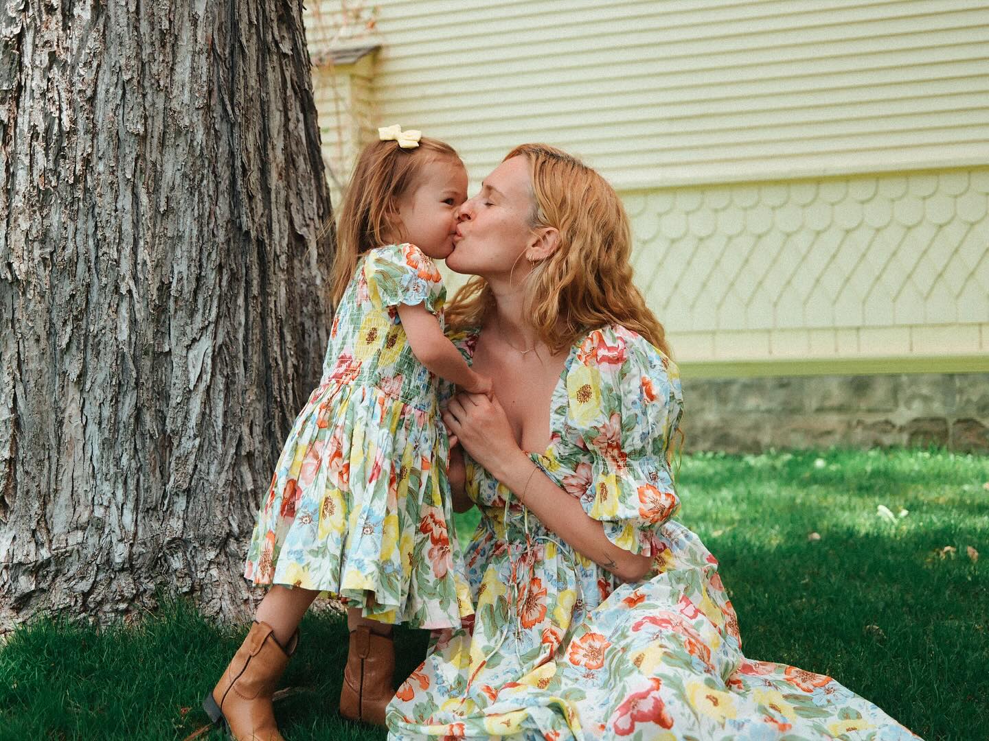 Rumer Willis kissing her daughter Lou on the lips.