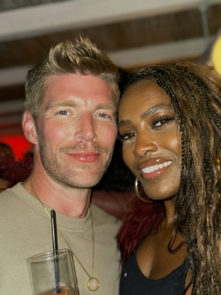 Kyle Cooke and Ciara Miller smiling together.