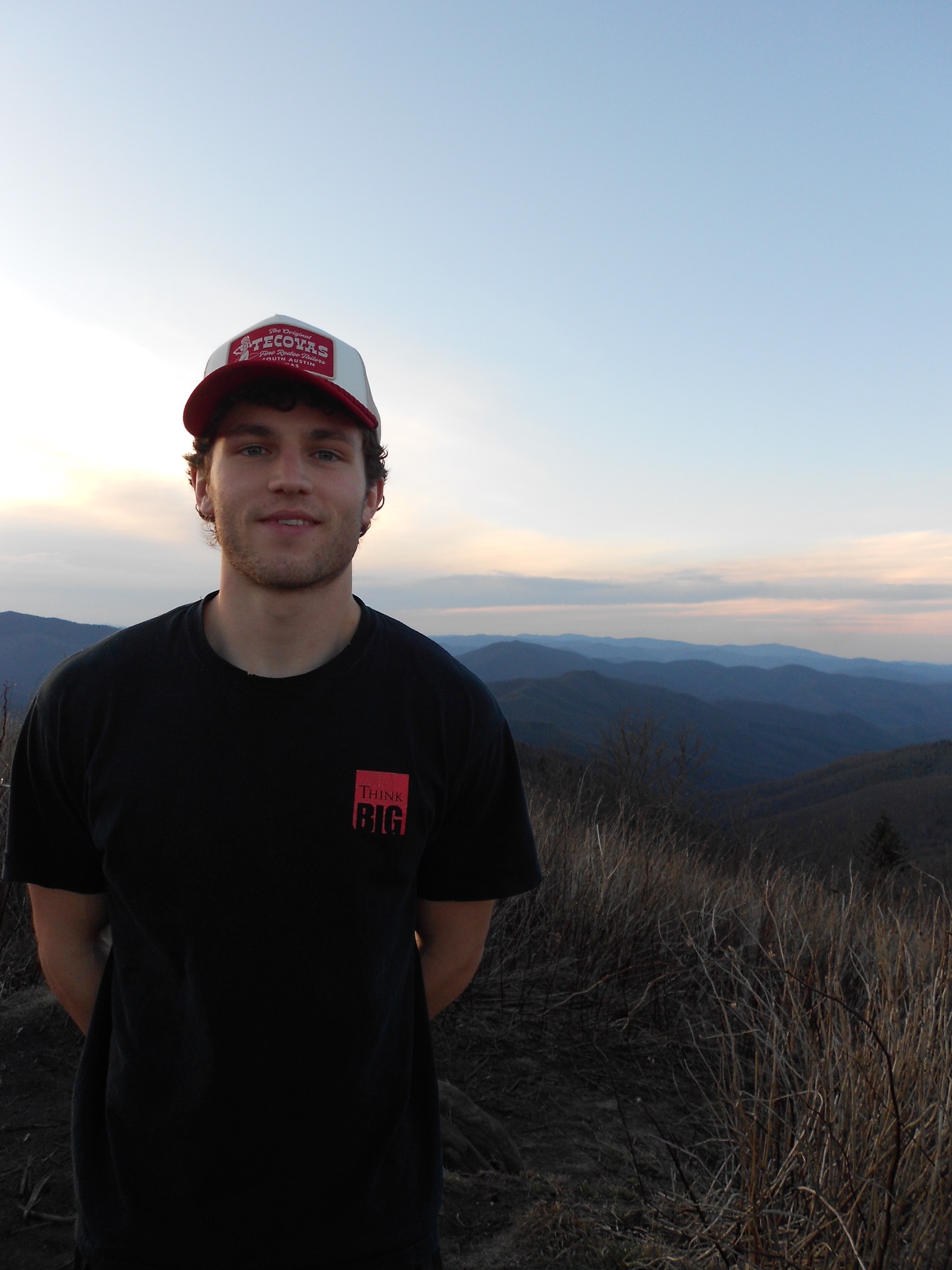 JC Kilcoyne poses with mountains in the background.