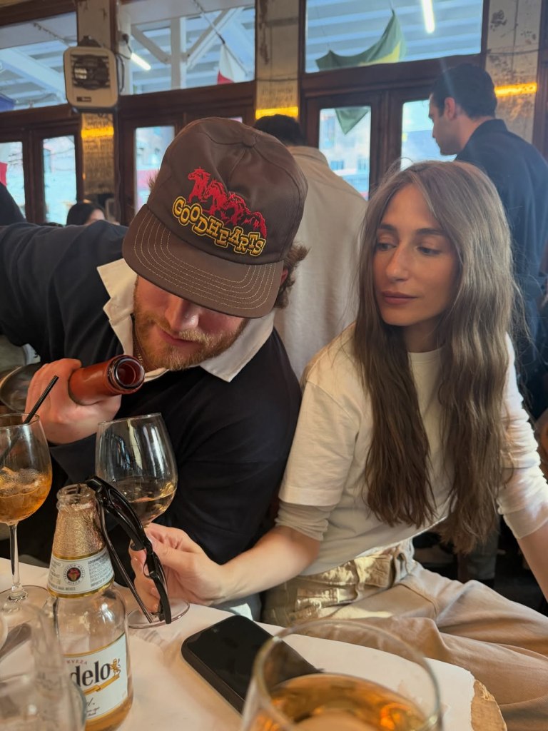 West Wilson and Amanda Batula at a table in a restaurant.