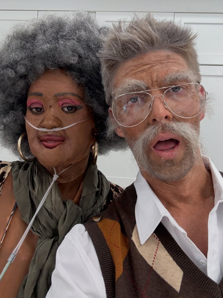 Kyle Cooke and Ciara Miller dressed as elderly people with wrinkles, gray hair, and Ciara with a nasal cannula.