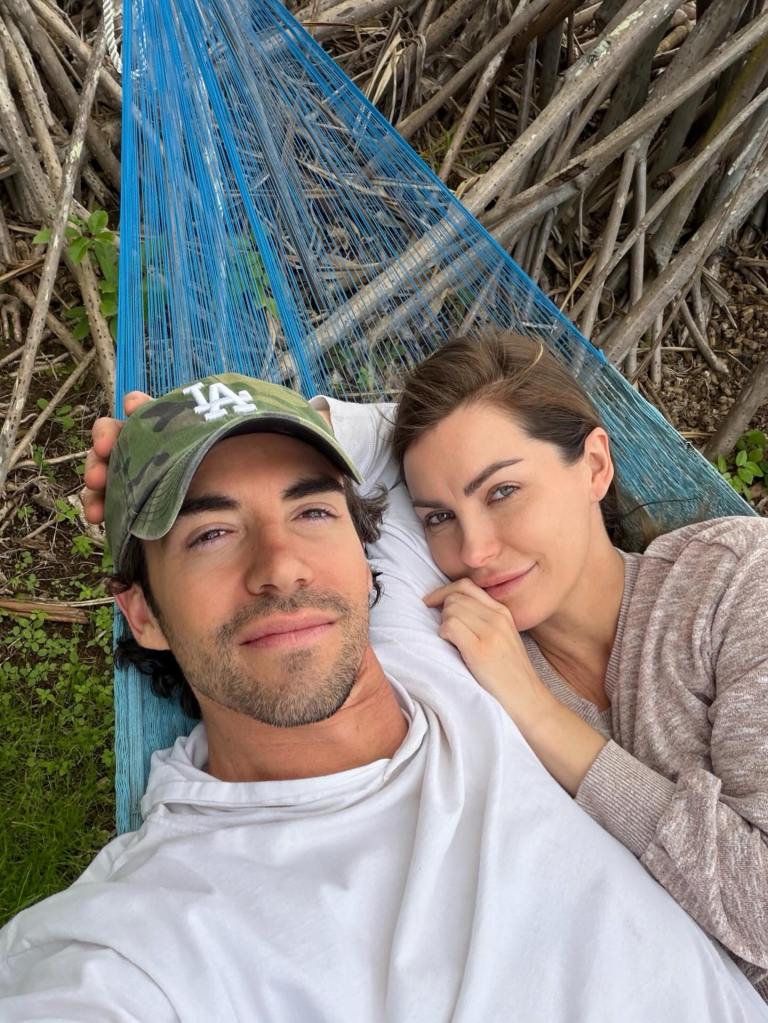 Crystal Harris and James Ward relaxing together in a blue hammock.
