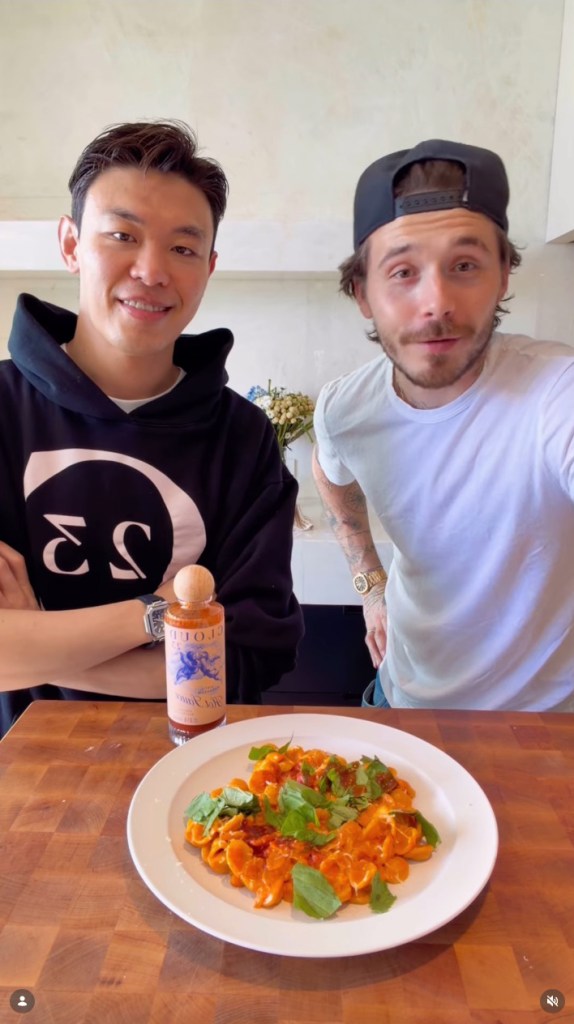 Brooklyn Beckham, in a white t-shirt and black baseball cap, and Zach Lu, in a blue hooded sweatshirt.
