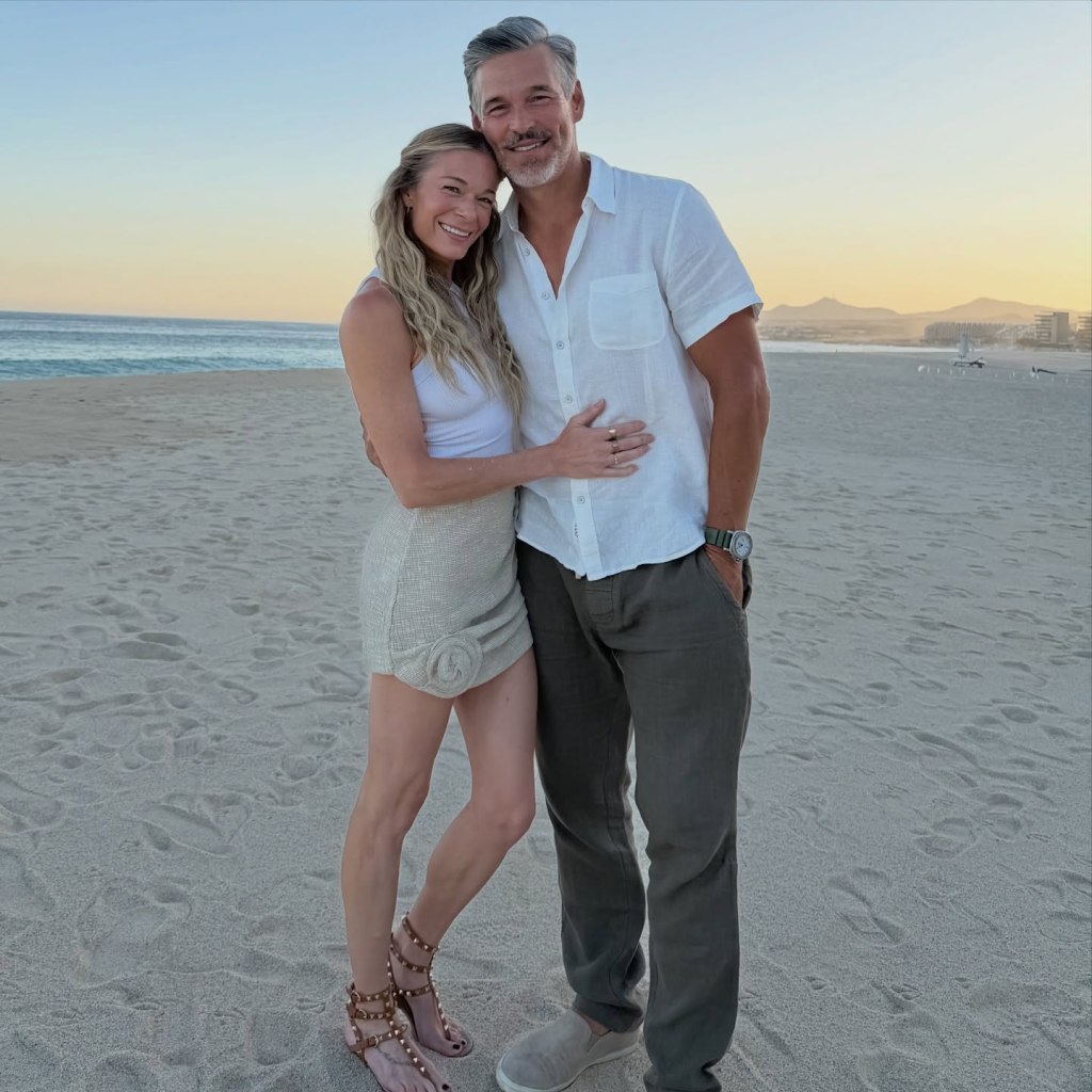LeAnn Rimes and Eddie Cibrian posing on a beach at sunset.