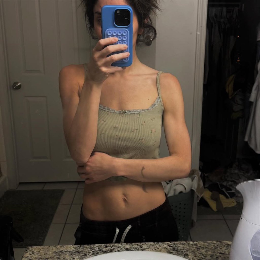 Taylor Frankie Paul posing in a mirror to show her body.