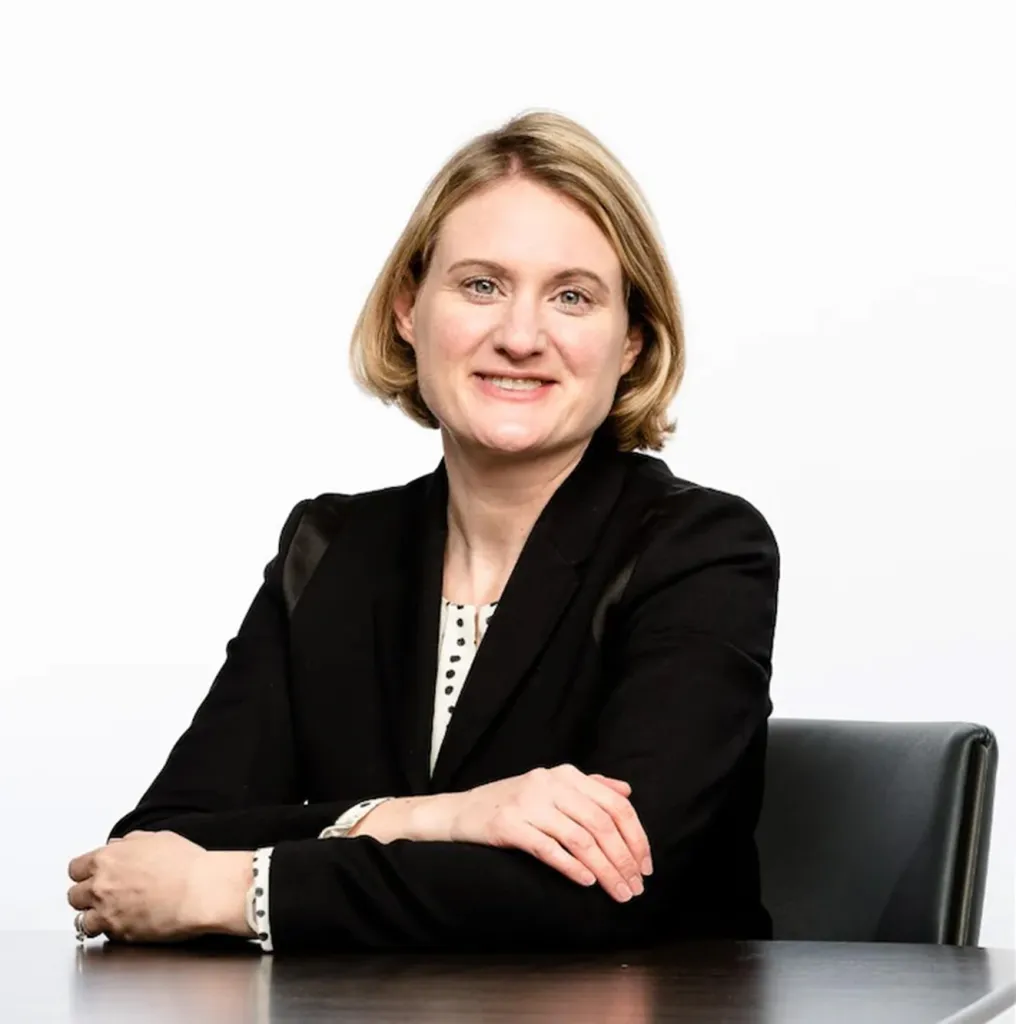 Hilary Maxson, CFO at Oracle, smiles at the camera while seated at a table.