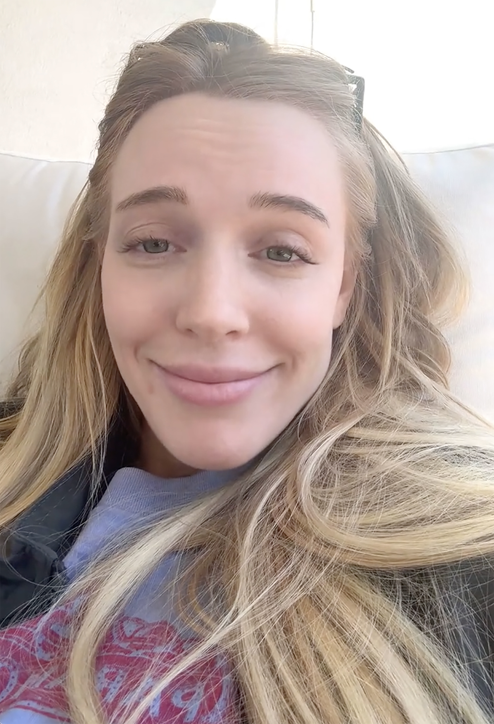 Alex Cooper with a slight smile.