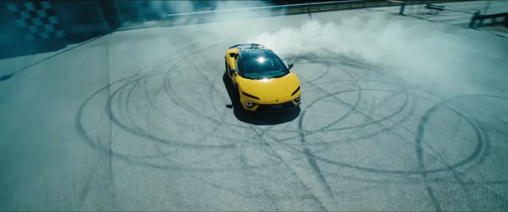 Yellow Lamborghini Temerario drifting on a track, creating smoke and tire marks.