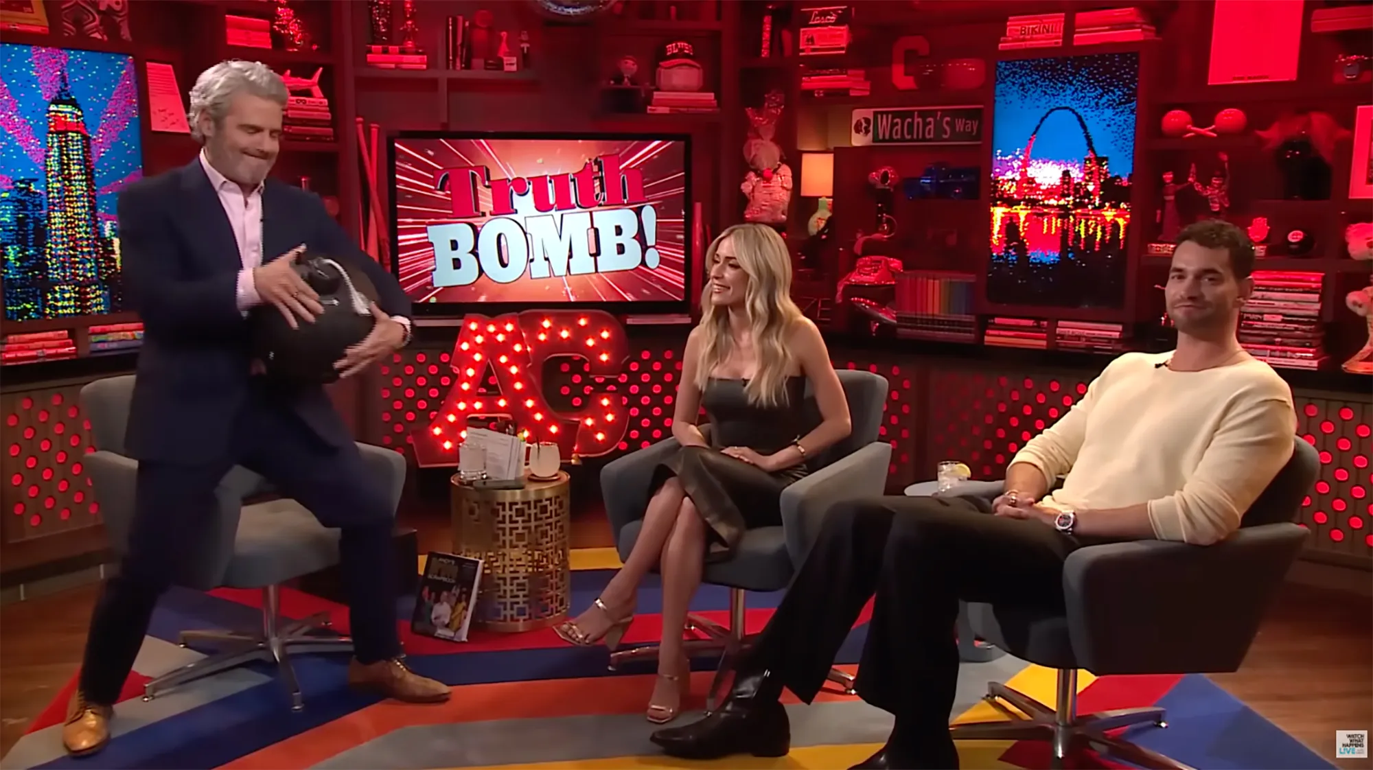 Jesse Solomon from Summer House sitting in a chair with two other people.