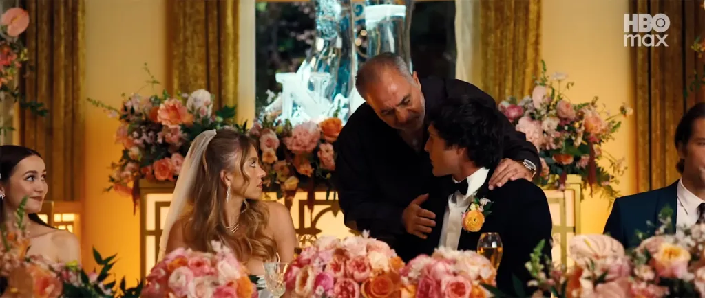 Jack Topalian in Euphoria, with a man in a black suit who is wearing a boutonniere.