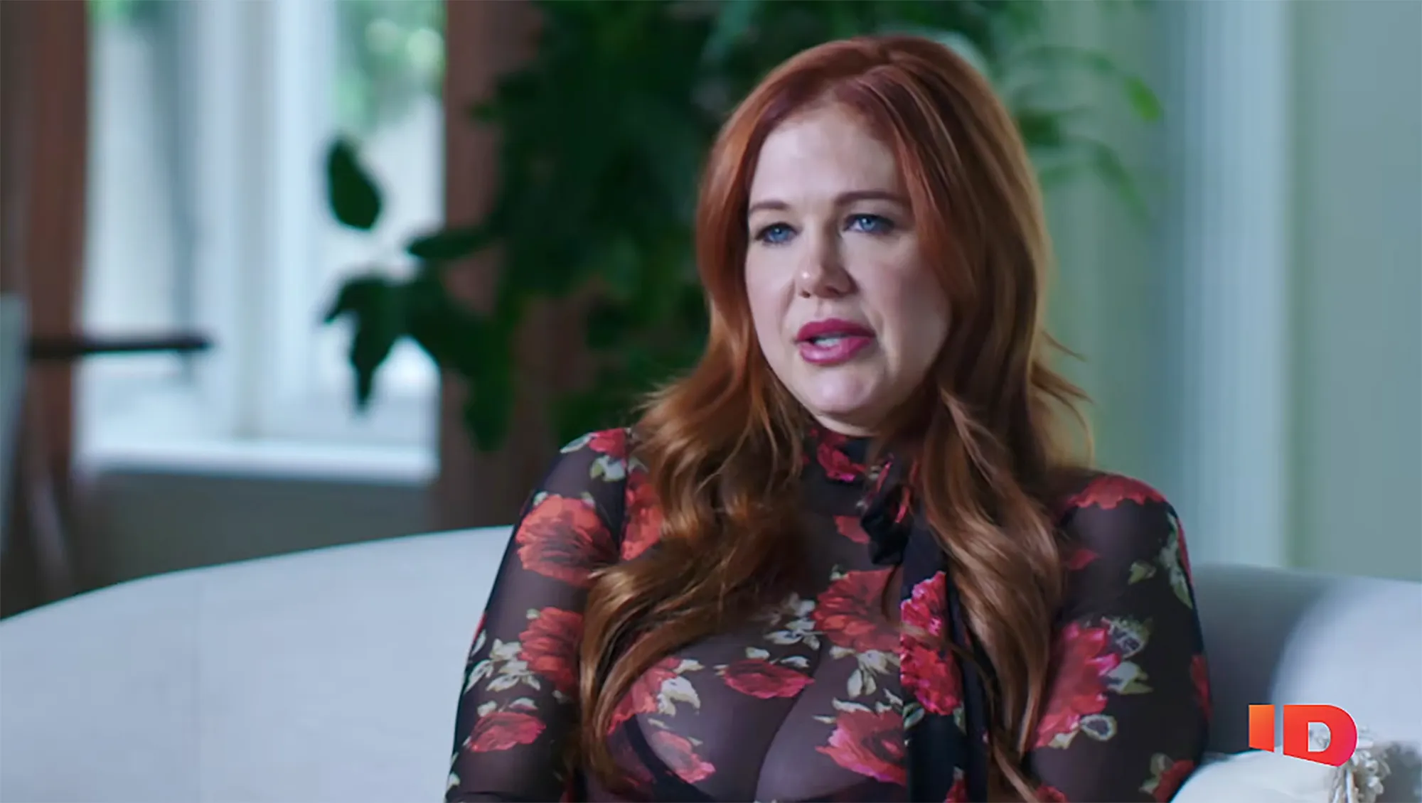 Maitland Ward in a black sheer top with red flowers.