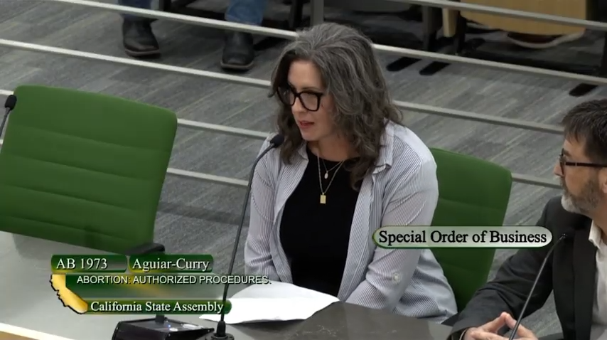 Mindy Hertzel speaking at the California State Assembly regarding AB 1973 for abortion-authorized procedures.