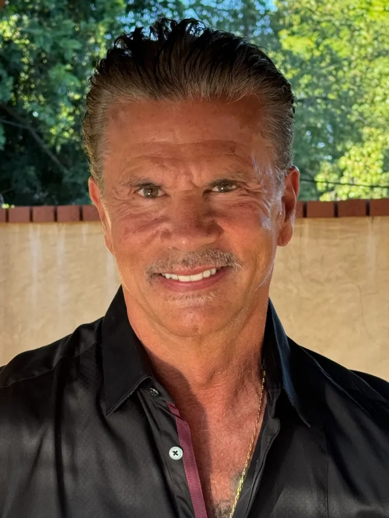 Lorenzo Lamas in a black shirt, smiling.