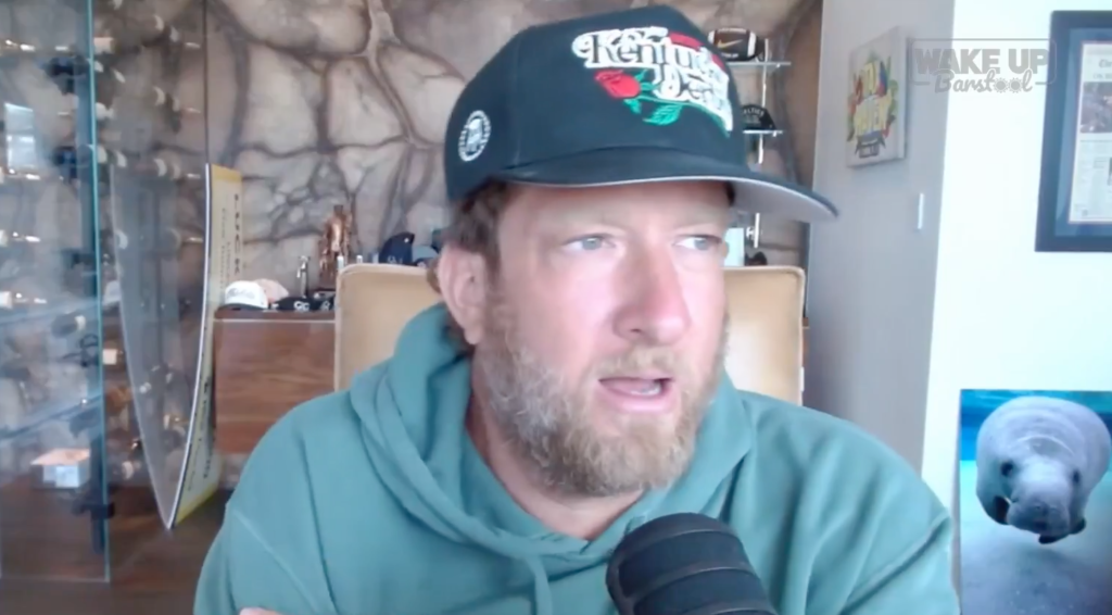 Dave Portnoy speaking with a microphone in front of him.