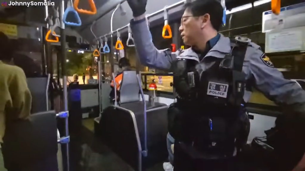 South Korean police speak with Ismael and his friend before kicking the two men off.