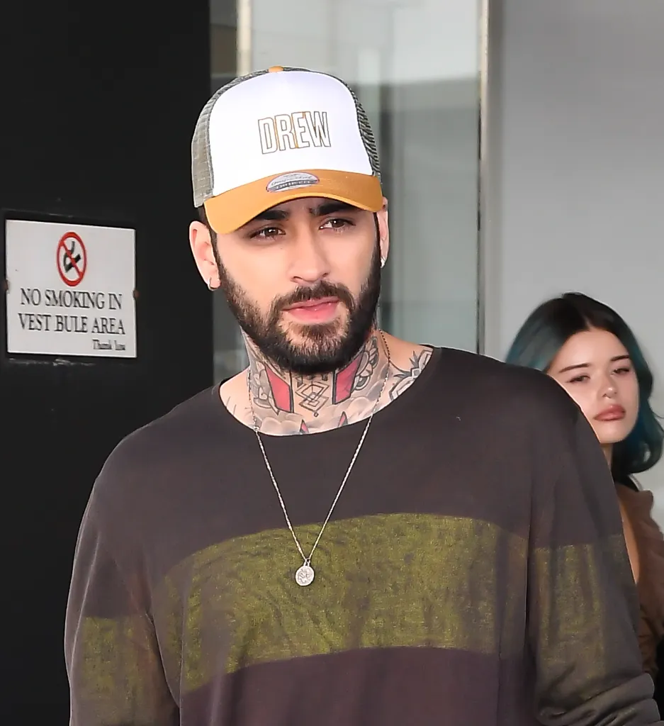 Zayn Malik wearing a white and gold 