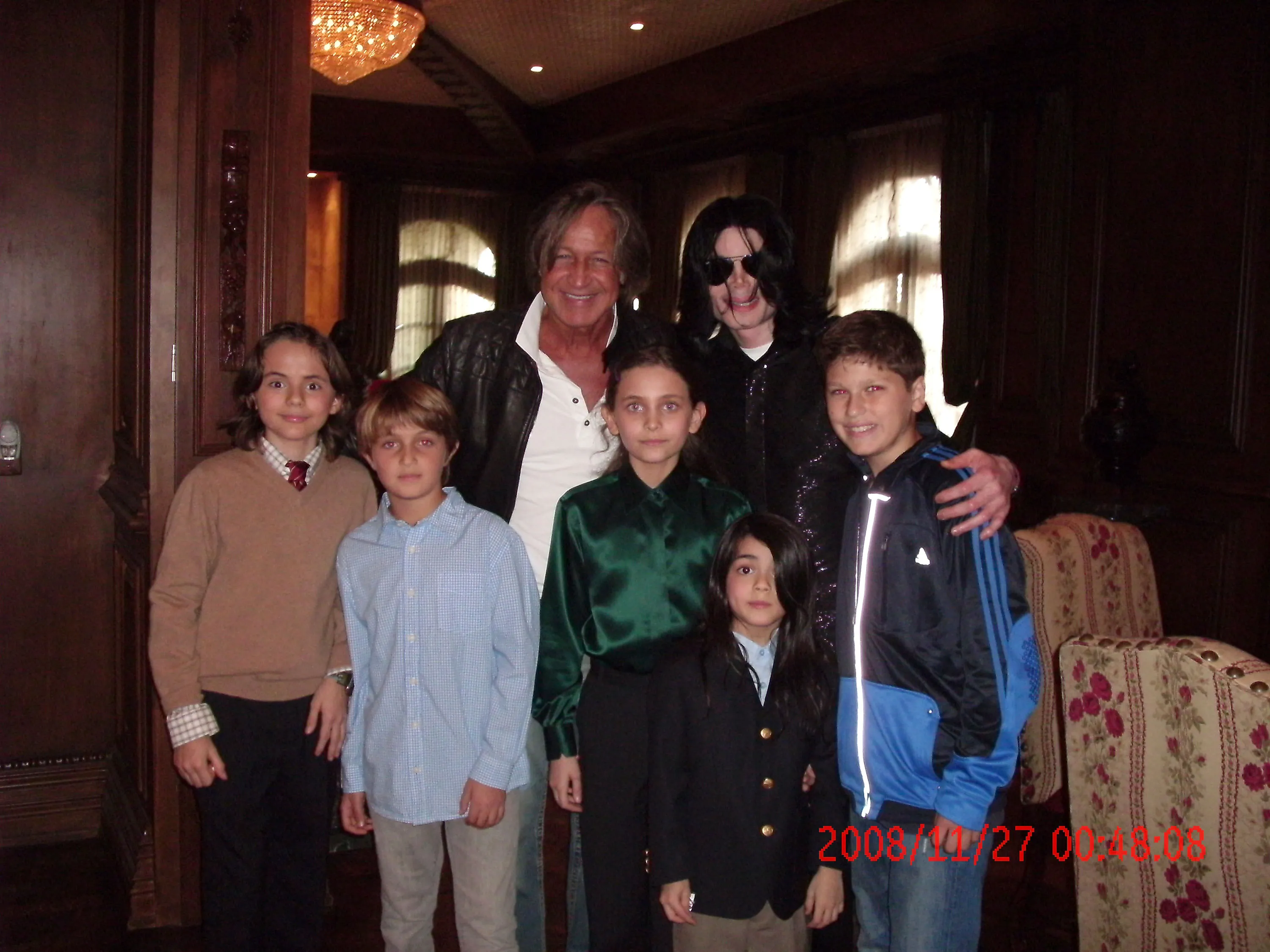 Mohamed Hadid, his children, and Michael Jackson with his children posing for a group photo.