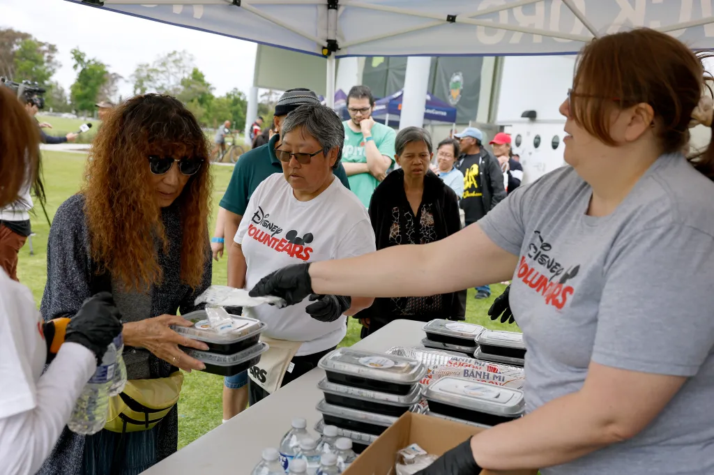 Volunteers passing out meals to evacuees at Freedom Hall.