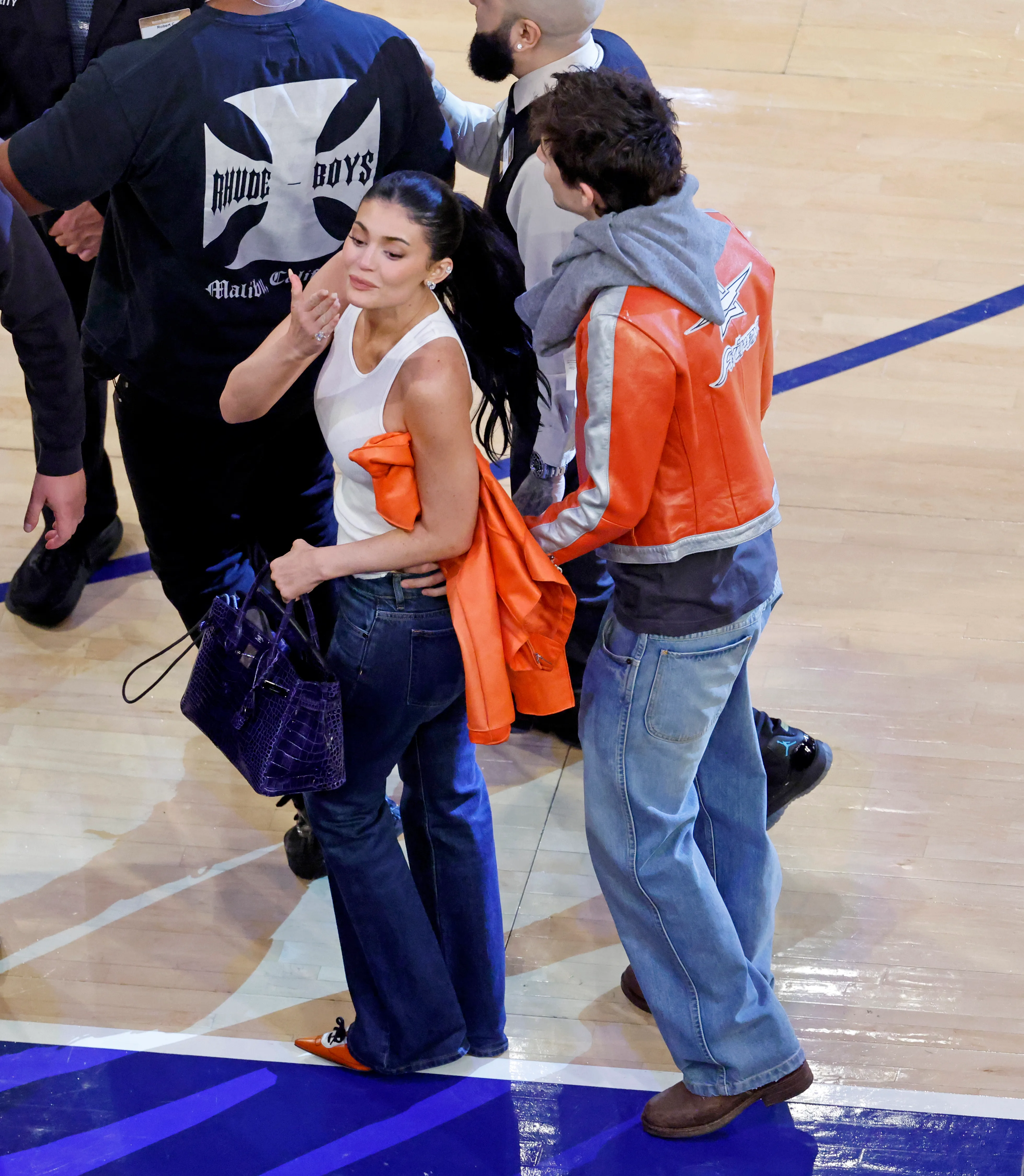Kylie Jenner and Timothee Chalamet walk off the court at Madison Square Garden.