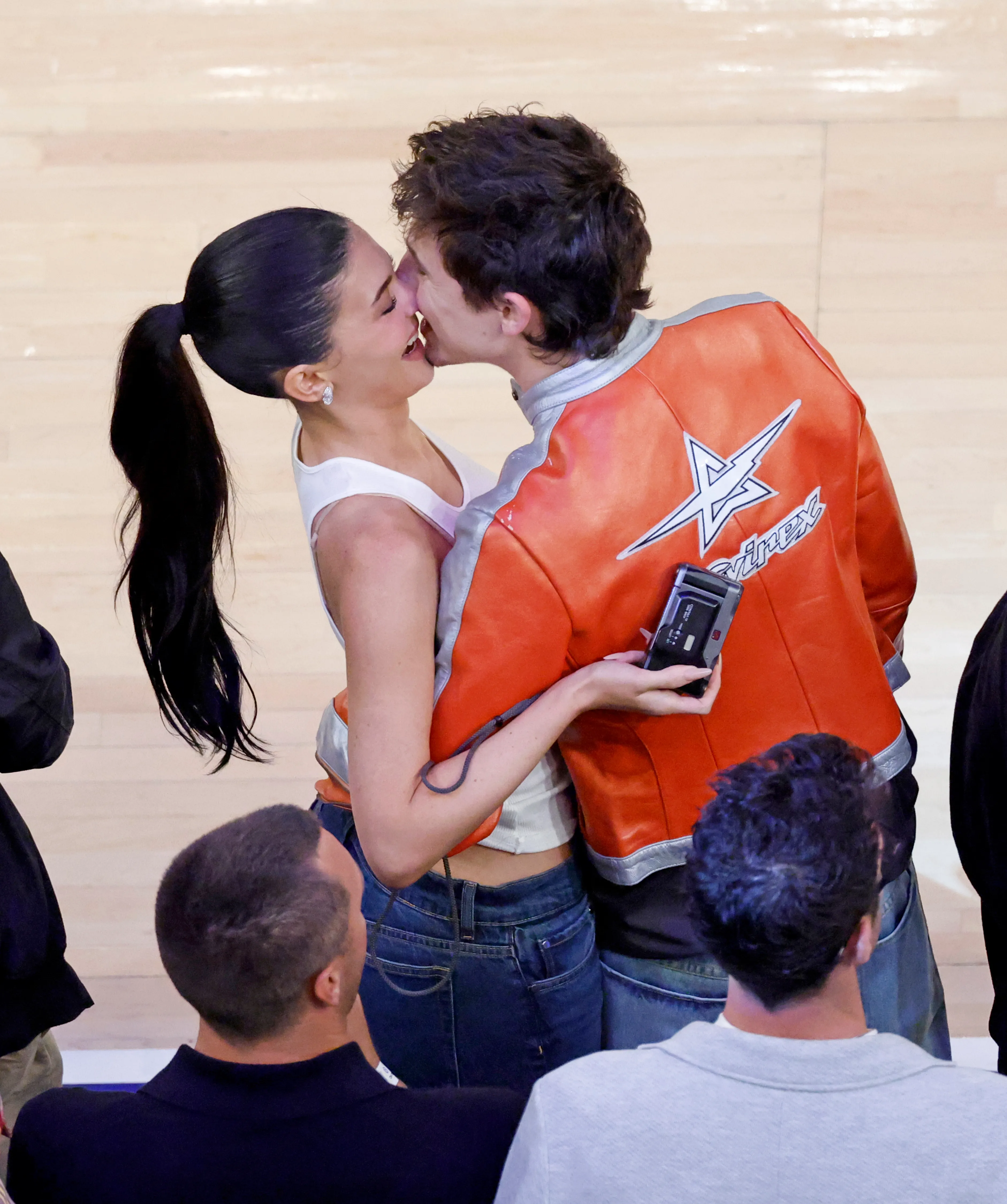 Kylie Jenner and Timothee Chalamet kiss courtside during an NBA Playoffs game.