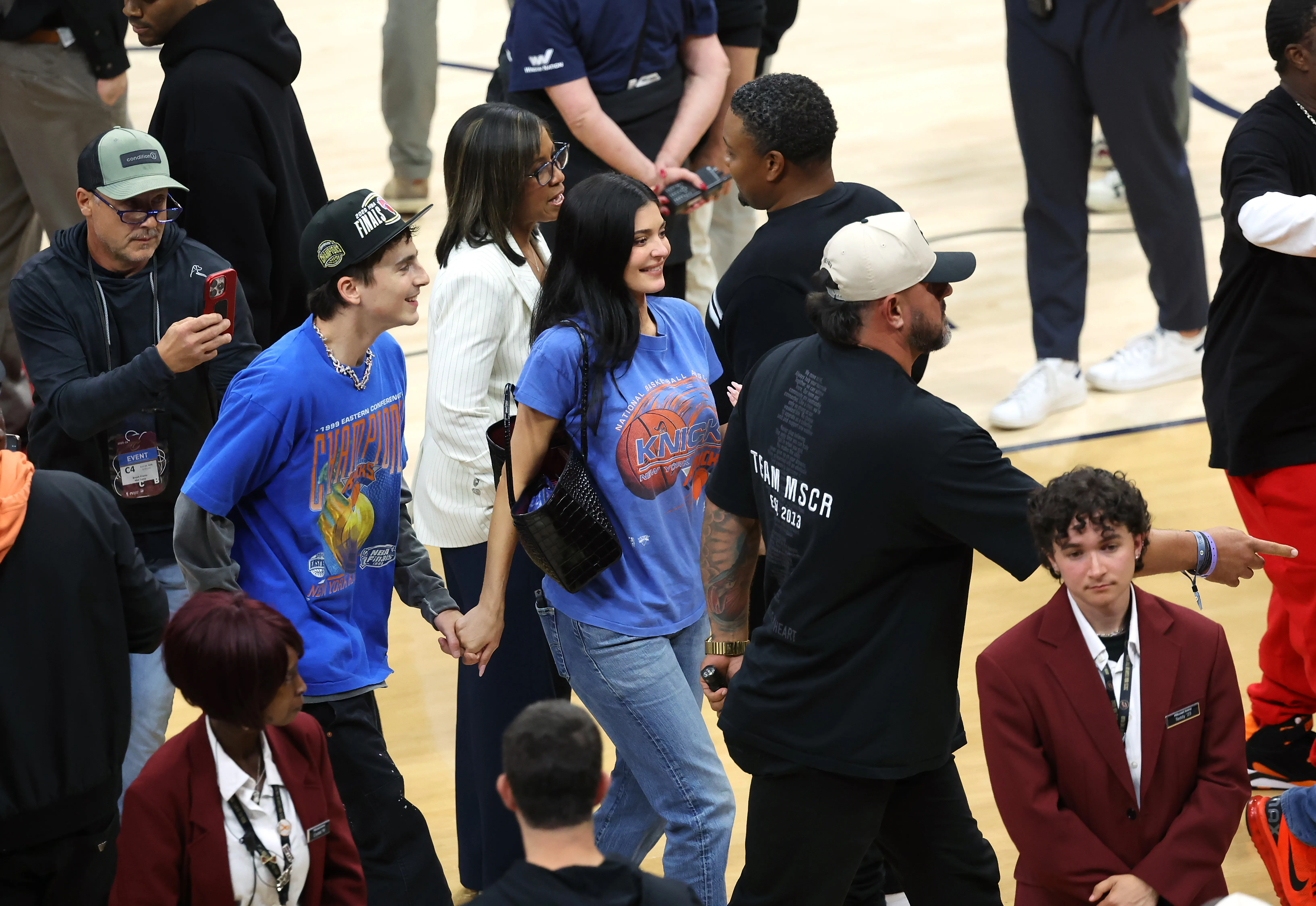 Actor Timothée Chalamet and Kylie Jenner walking off the court, holding hands, at the 2026 NBA Eastern Conference Final.