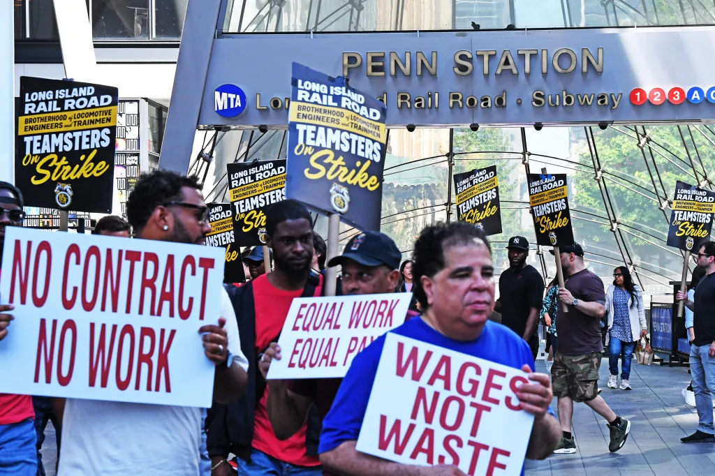Train workers picket outside Penn Station. 