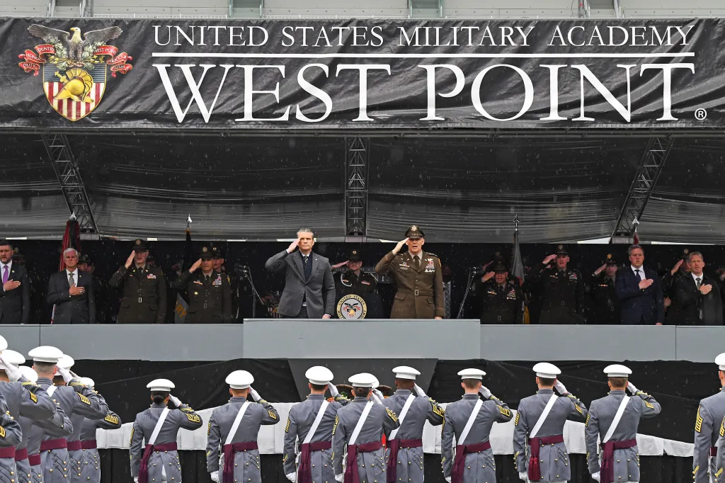 Secretary of War Pete Hegseth and military officials salute during the West Point Graduation ceremony.