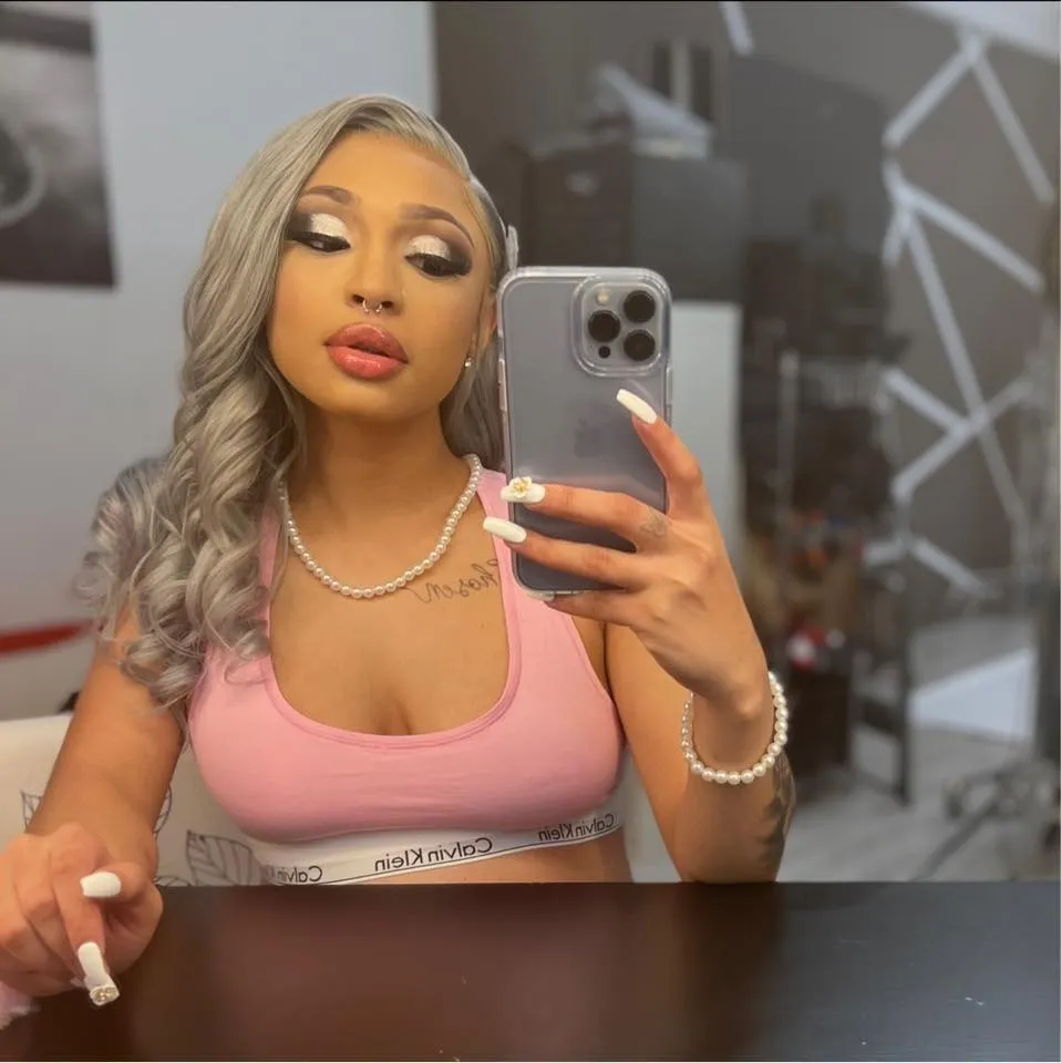 A selfie of Azsia Johnson in a pink top. 