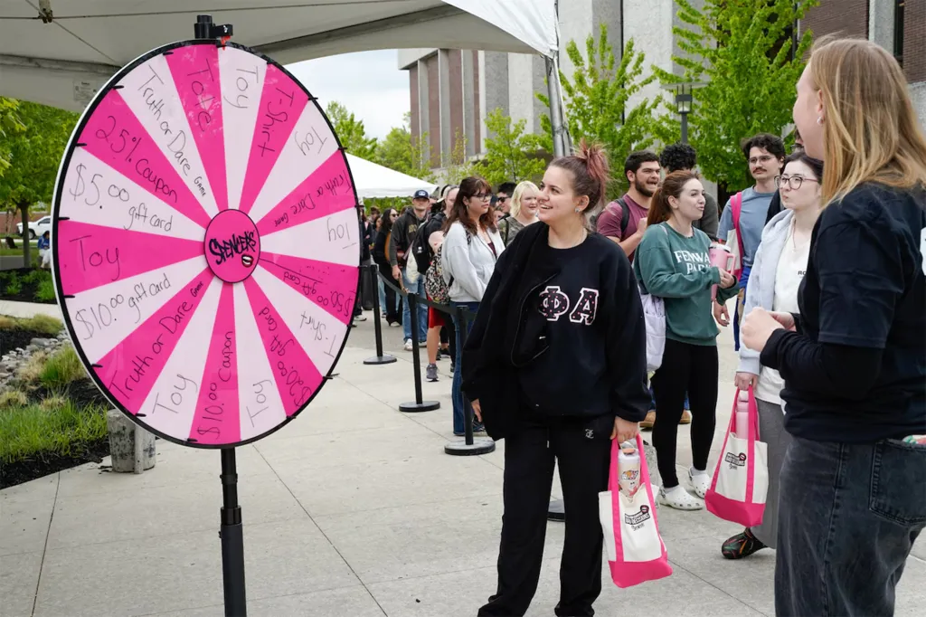 Students at Rowan University line up to spin a prize wheel at the 