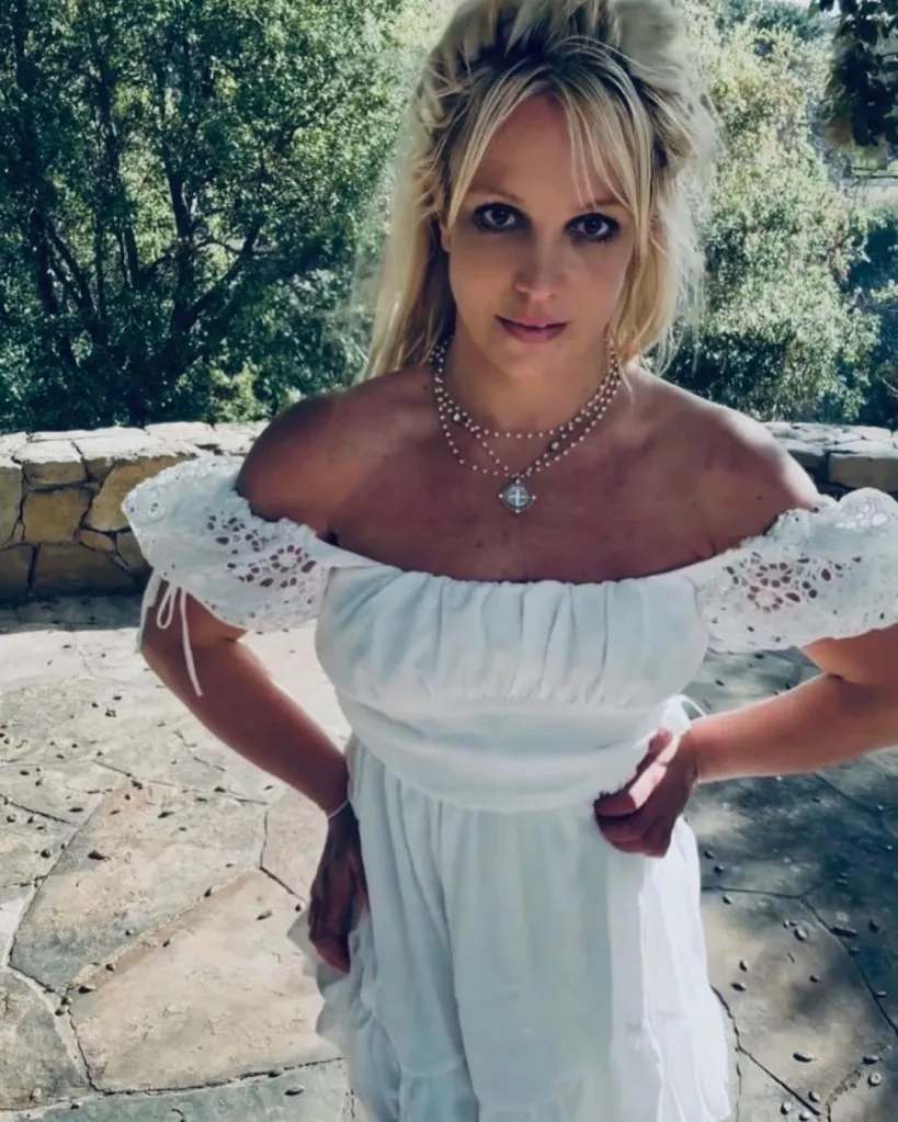 Britney Spears in a white off-the-shoulder dress.