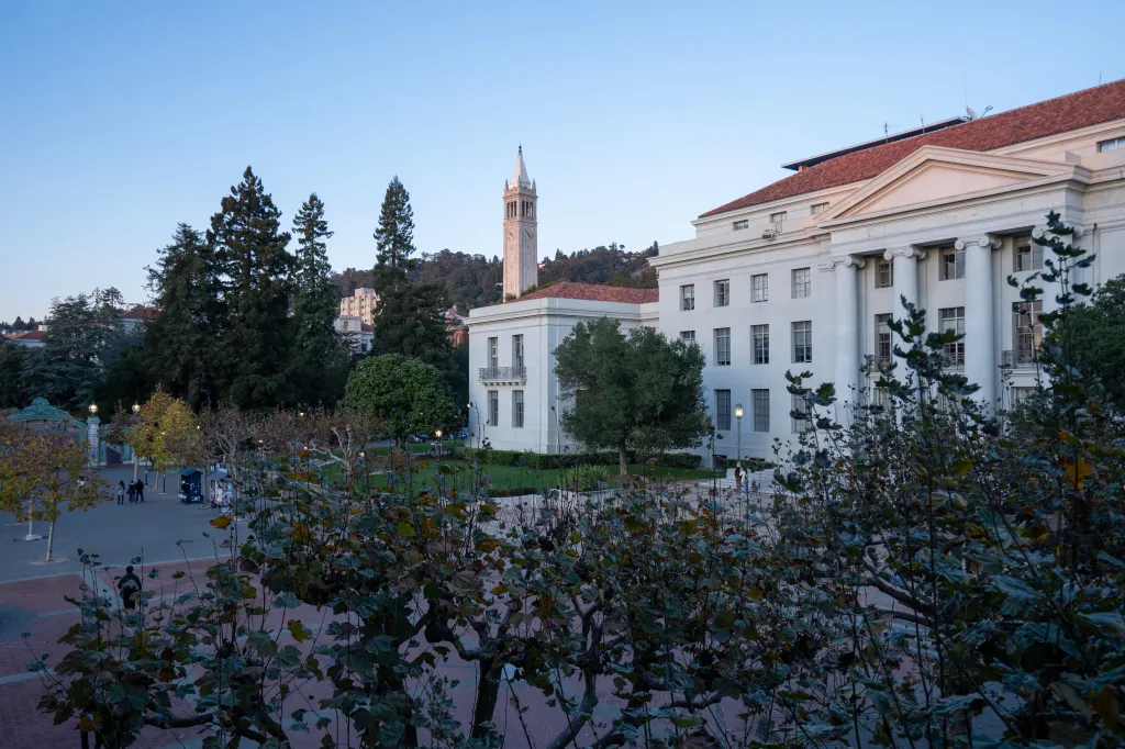 The Sproul Plaza and Sproul Hall at UC Berkeley at dusk, with the Sather Tower in the background.
