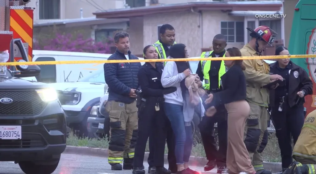 First responders and distressed family members at the scene of a fatal two-vehicle collision.