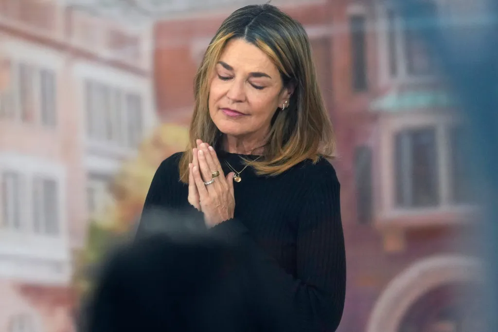 Woman with closed eyes and clasped hands in prayer.