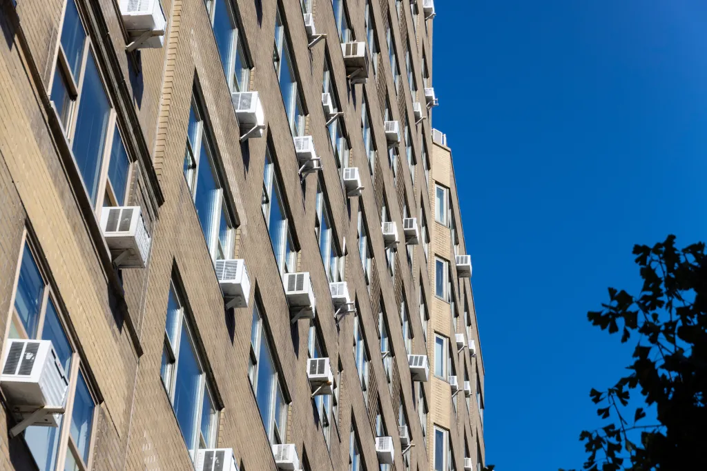 Many air conditioners installed at windows of residential buildings along Park Avenue in Midtown Manhattan.