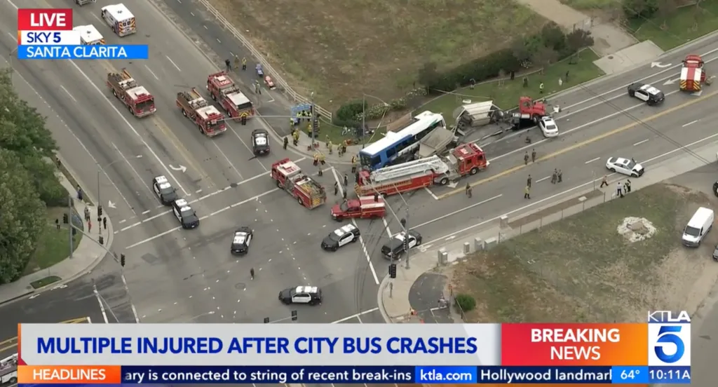 Aerial view of a city bus crash scene with multiple emergency vehicles and personnel in Santa Clarita.