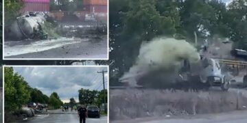 Horror as train collides with truck carrying septic tank, seriously injuring driver: video
