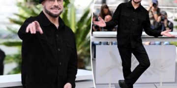 John Travolta models another kooky beret at Cannes hours after being trolled for striking new look