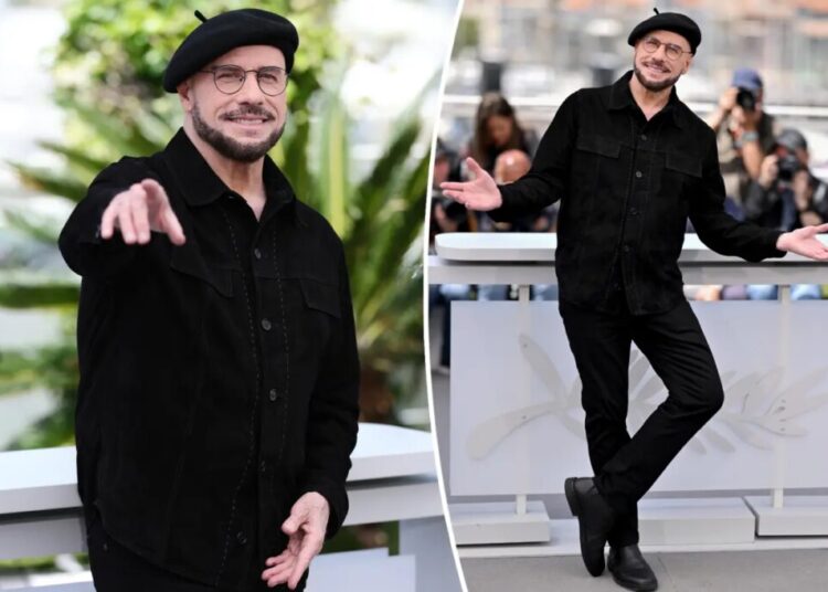 John Travolta models another kooky beret at Cannes hours after being trolled for striking new look