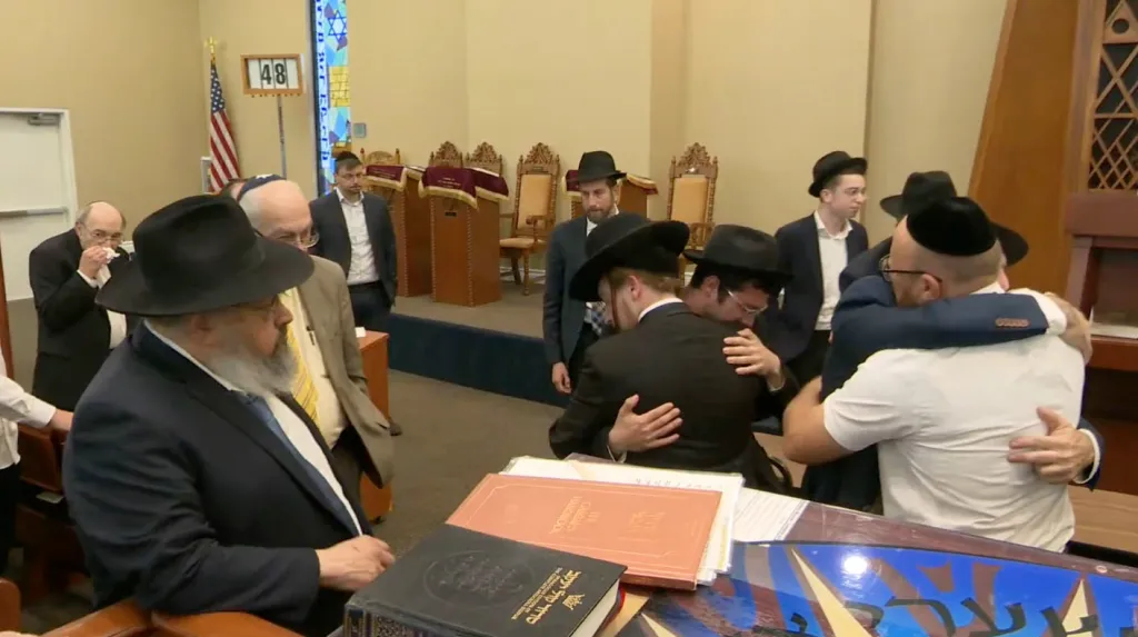 Mourners embracing at the funeral of Adina Liba A'H Bas Zev Chaim Nevo in Los Angeles.