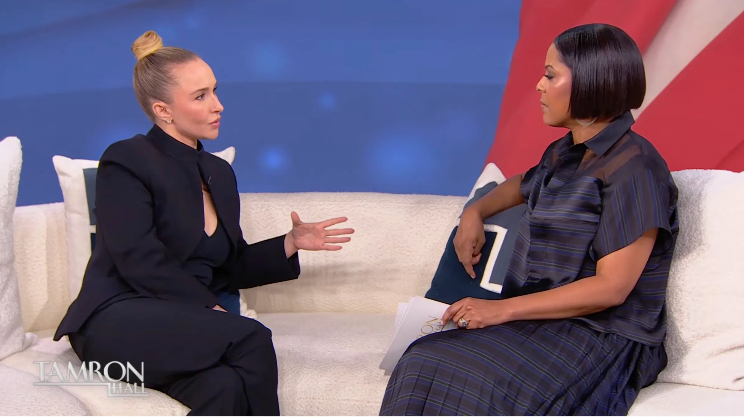 Tamron Hall and Hayden Panettiere seated on a white sofa during an interview on The Tamron Hall Show.