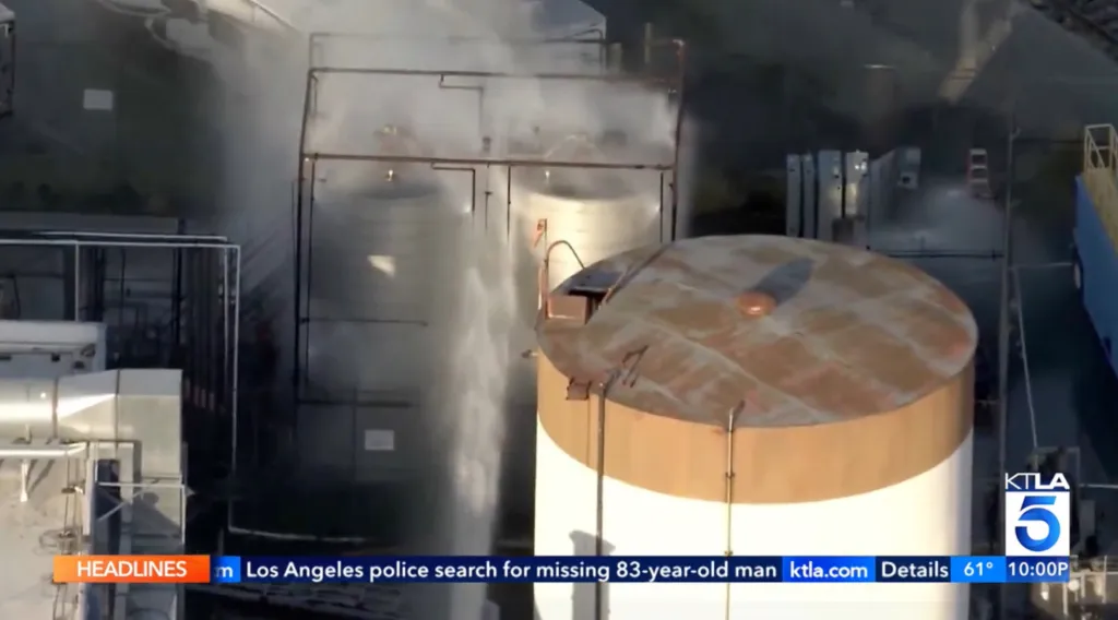 A storage tank spewing toxic chemicals into the air, causing evacuations.