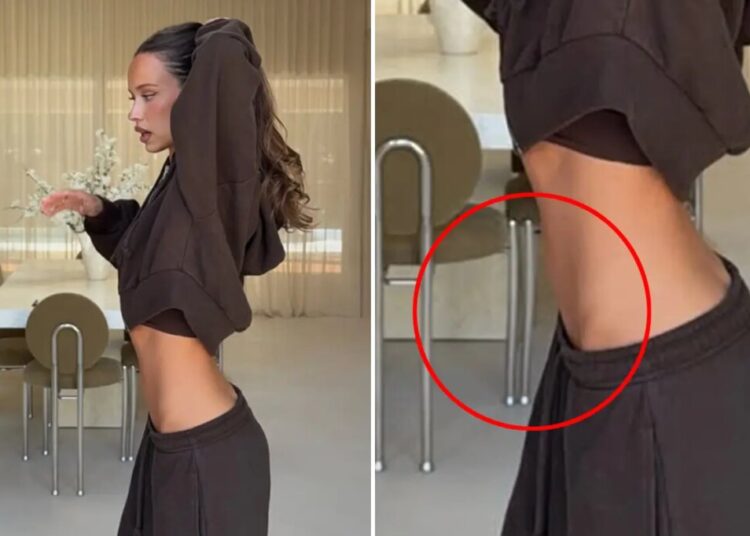 Influencer trashed for apparently manipulating photo to flatten belly — with bizarre result: ‘OMG this is insane’