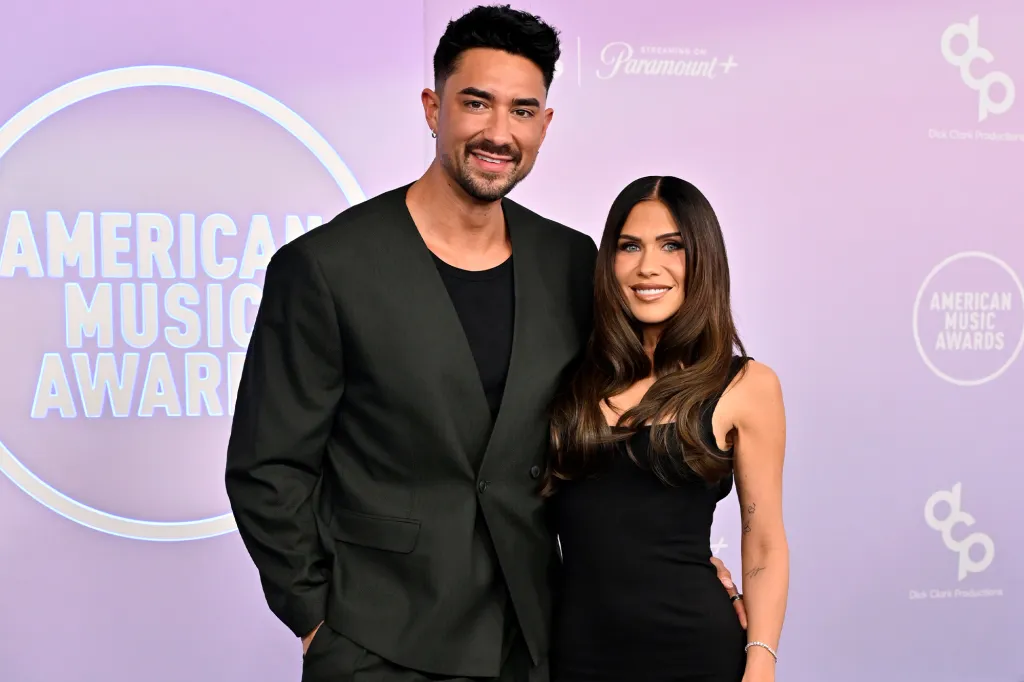 Jax Taylor and Brittany Cartwright pose on the red carpet at the American Music Awards.