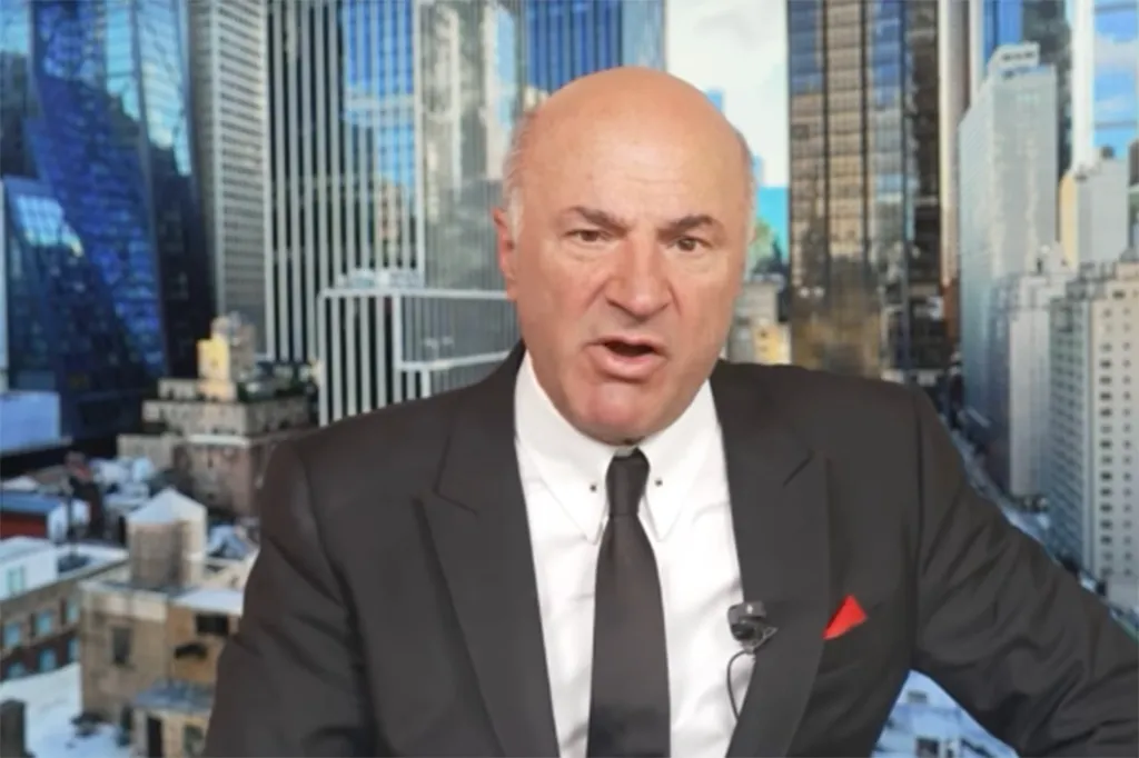 Kevin O'Leary speaking with a cityscape in the background.