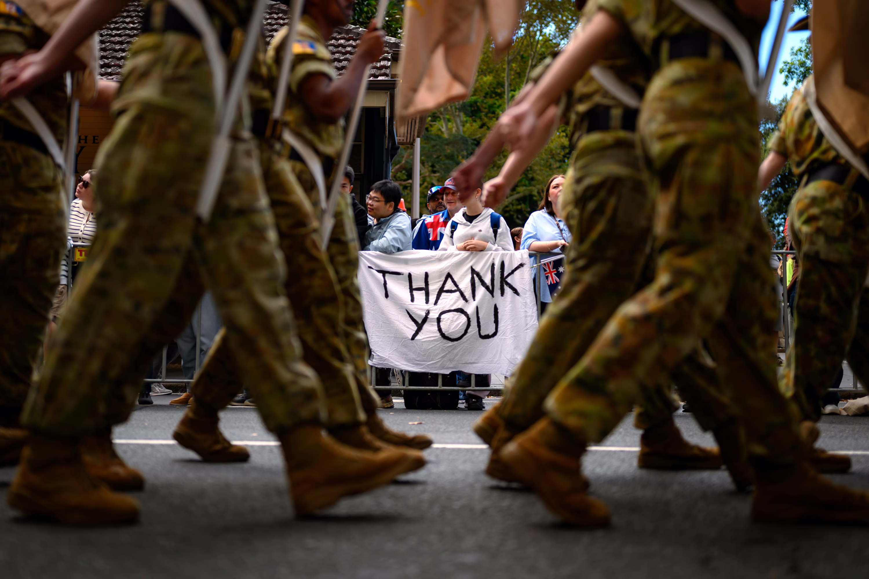 A person holds a sign reading 